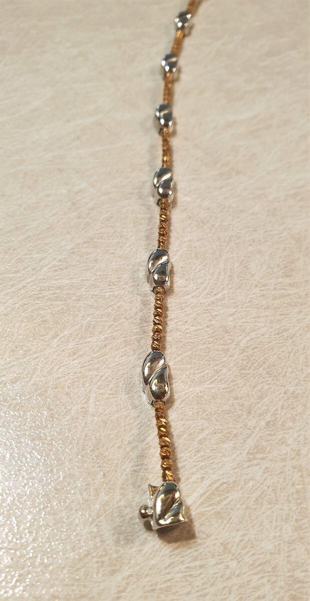 # Halbstarres Armband mit facettierten Kugeln aus Roségold und 2 polierten Kommas aus Weißgold