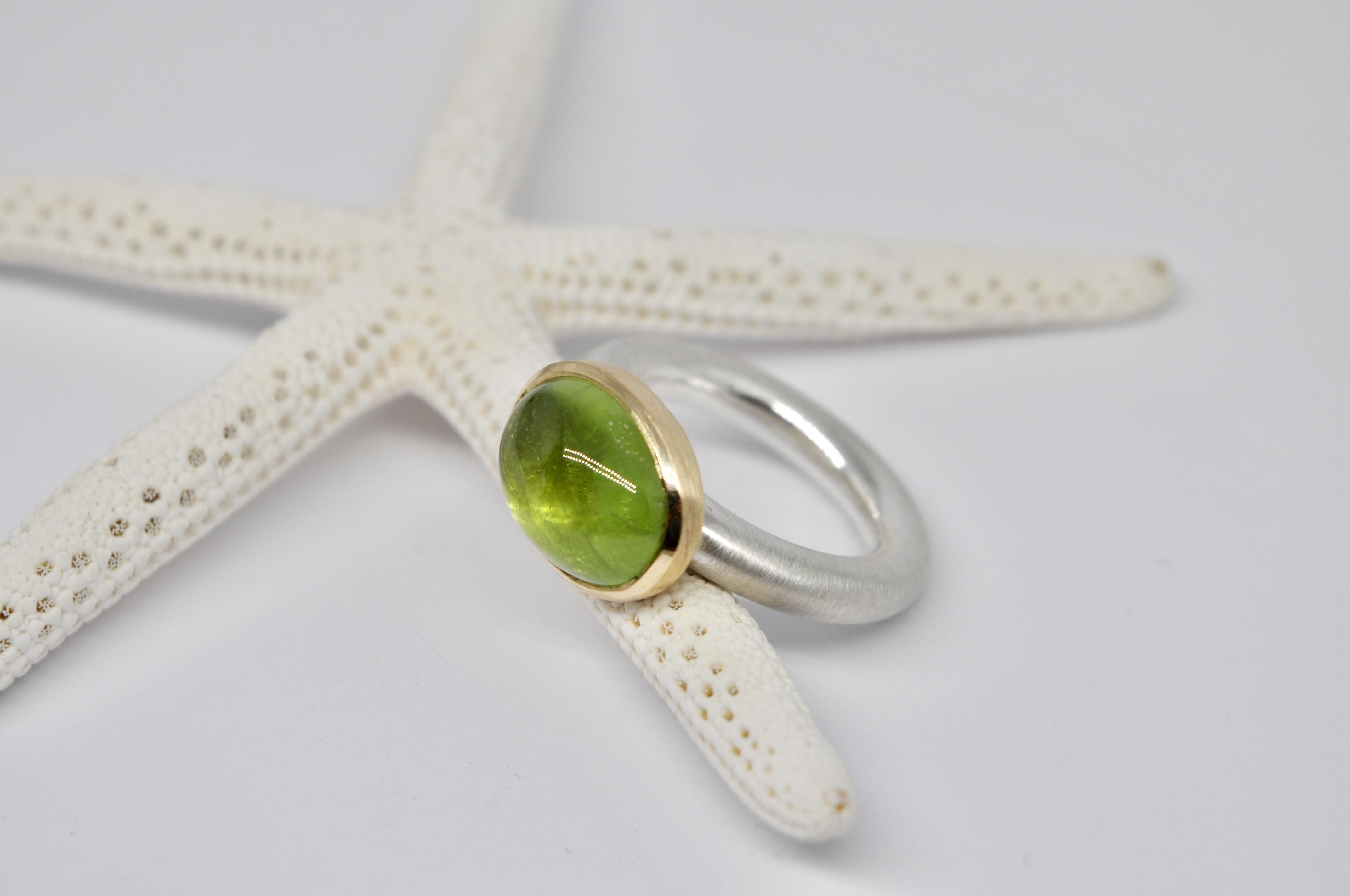 Silver and gold ring with peridot cabochon