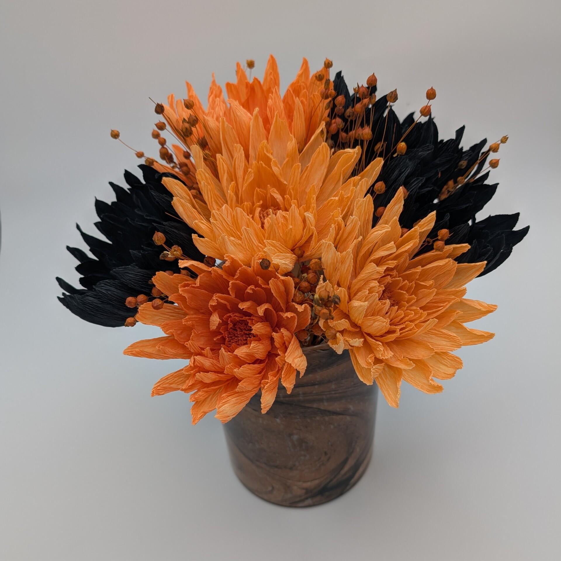 Black and orange-toned bouquet and vase
