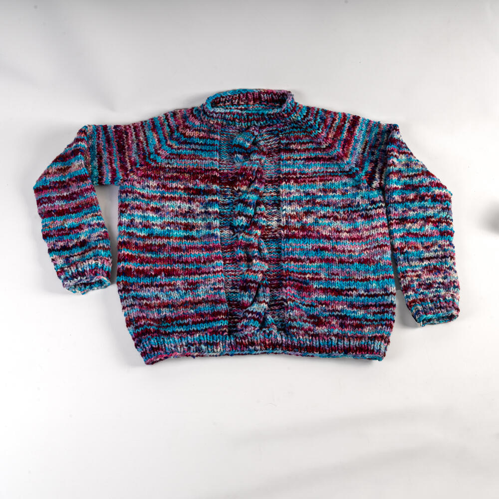 Colorful children's sweater with cable pattern, hand-knitted