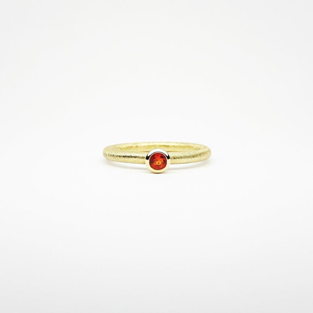 "combiring mini", 18kt yellow gold and fire opal Ø3mm.