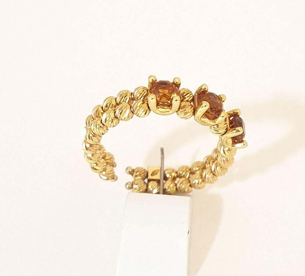 Yellow gold ring with 2 bands and 3 citrine stones in a wedding band style