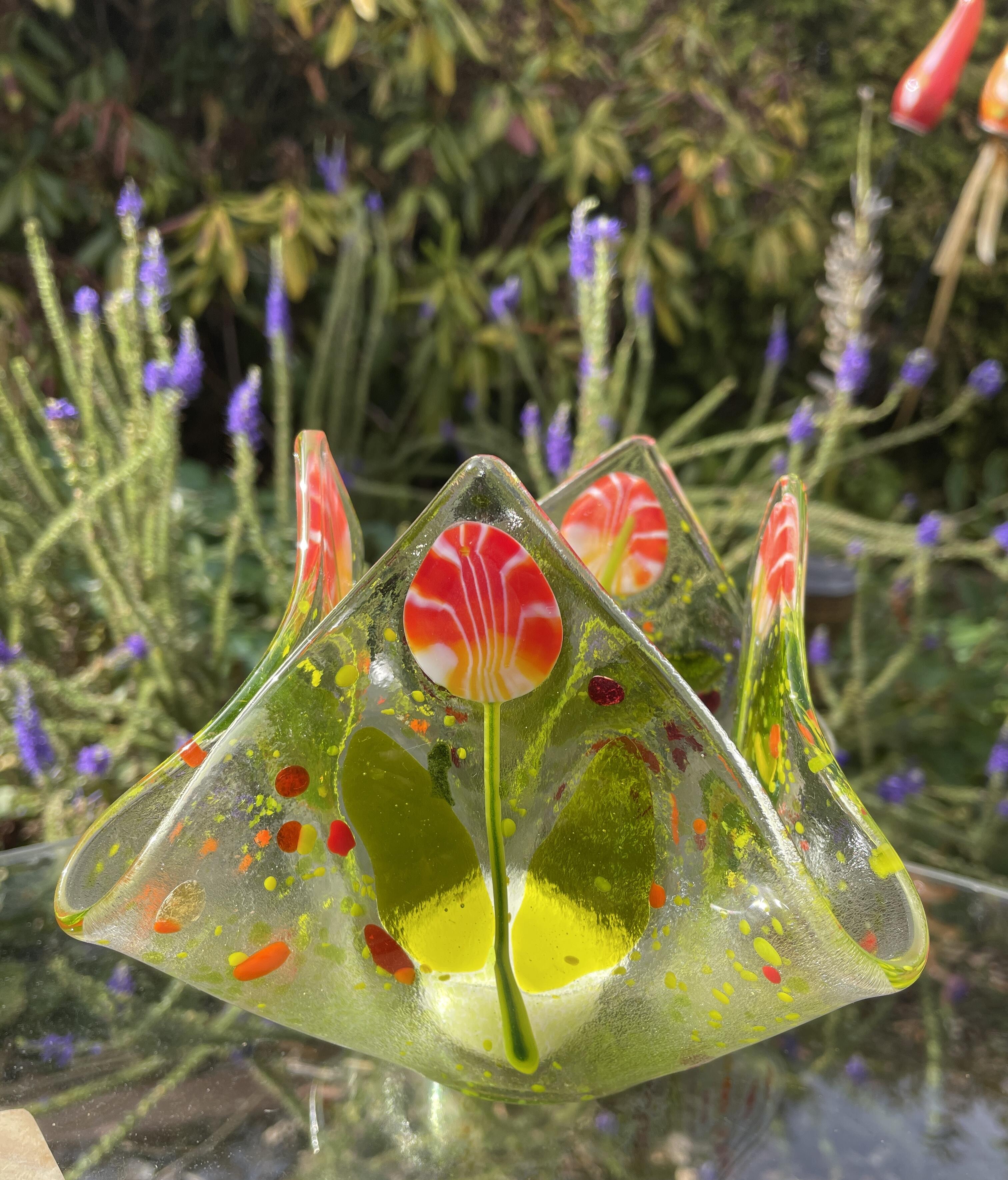 Tea light candle featuring millefiori, red-orange floral motif, one-of-a-kind.