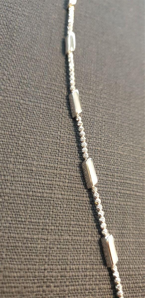 # Semi-rigid white gold bracelet faceted beads and polished white gold tubes