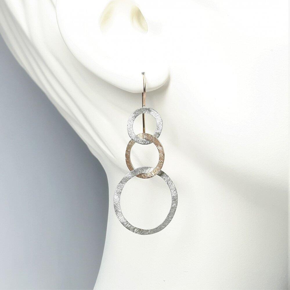 Stud earrings "dancing circles", 18kt rose gold and silver.