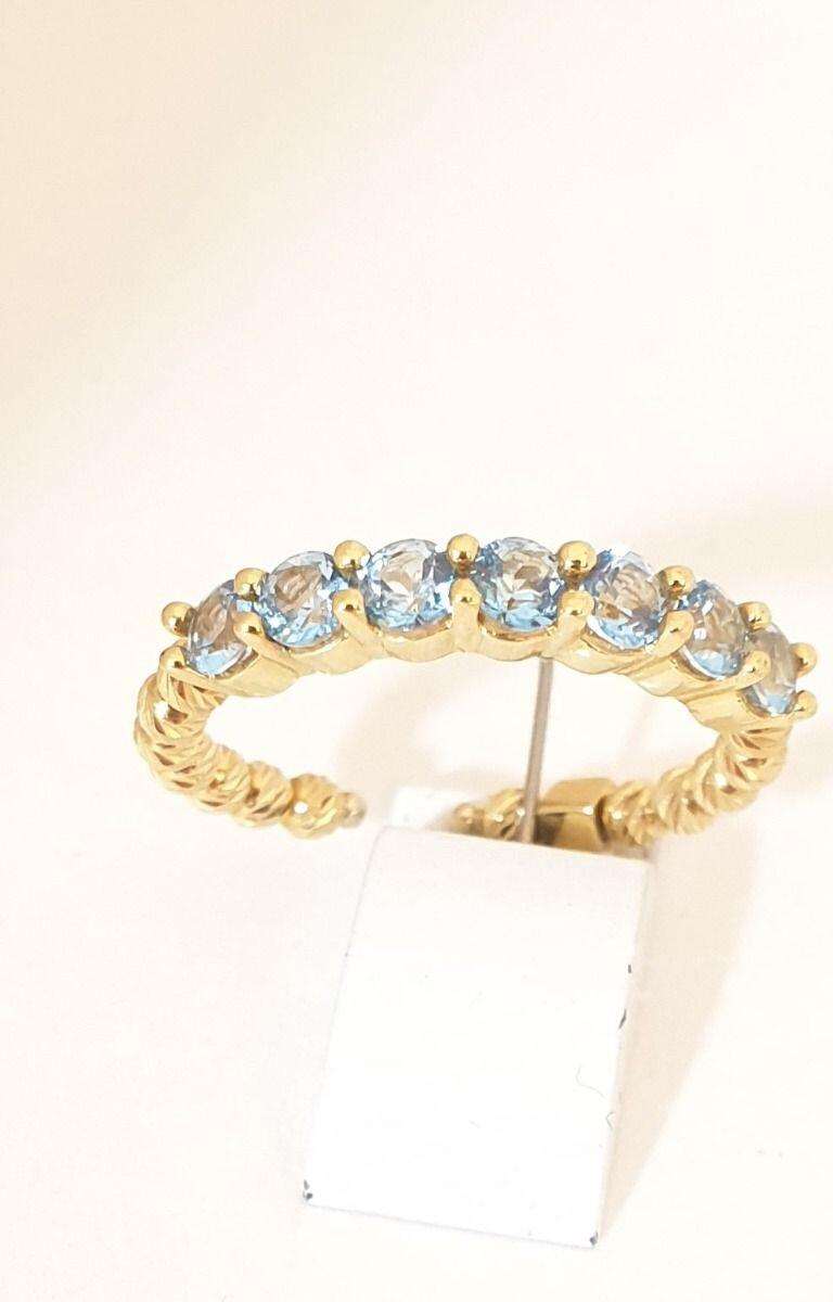 # Bague or jaune 18K ouverte, avec 7 pierres topaze bleu & billes facettées en or jaune 18K