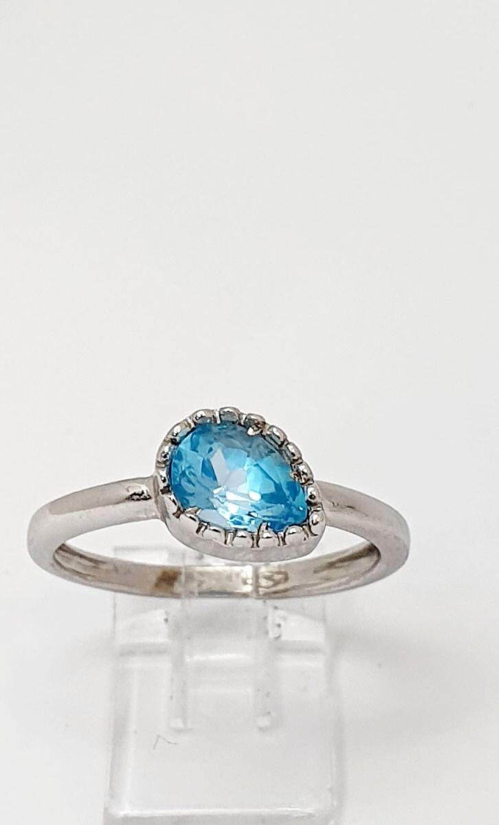 # Bague or blanc avec topaze bleu, forme poire entourage clos ciselé